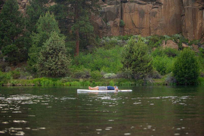 A man relaxing and floating on the river