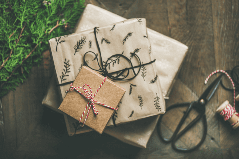 presents wrapped in brown paper with red and whtie colored string