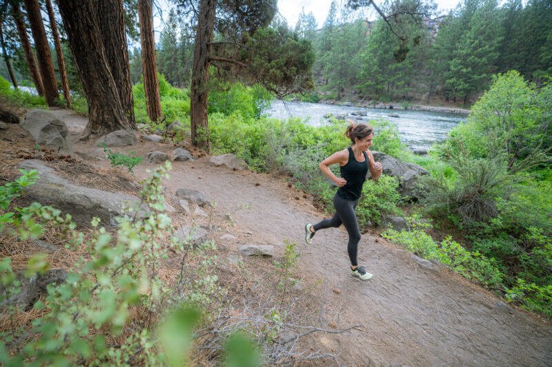 Woman running in the forest - Mission Farms CBD